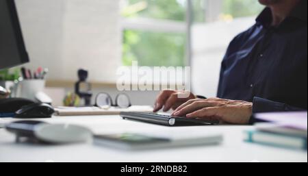 Man Working In Office On Desktop PC Stock Photo