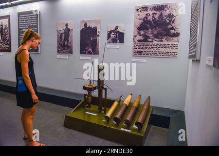 HO CHI MINH CITY, May 16, 2016 -- A tourist visits the War Remnants Museum in Ho Chi Minh City, Vietnam, May 16, 2016. The War Remnants Museum is located in District 3 of Ho Chi Minh City. Opened in 1975, the museum is specialized in researching, collecting, preserving and exhibiting the remnant proofs of Vietnam war crimes and their consequences, which calls for people to say no to wars and say yes to peace. With the annual reception capacity of more than 500,000 visits, the museum has become one of the well-known cultural and tourist sites for both Vietnamese and foreign tourists. ) VIETNAM- Stock Photo