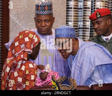 (160519) -- ABUJA, May 19, 2016 -- Nigerian President Muhammadu Buhari (Front-R) talks to the rescued Chibok schoolgirl, Amina Ali-Nkeki (Front-L), during a meeting at the Presidential Villa in the capital Abuja, Nigeria, May 19, 2016. Nigerian President Muhammadu Buhari on Thursday met the rescued Chibok schoolgirl, Amina Ali-Nkeki, and her months-old baby, her mother and her brother. Ali-Nkeki was the first Chibok girl to be rescued by Nigerian authorities. A total of 276 girls were abducted by Boko Haram militants from their secondary school dormitories in Chibok town in the northeastern Bo Stock Photo