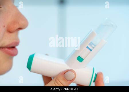 girl uses a medical inhaler with medicine Stock Photo