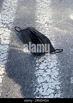 Face Mask Litter on a street Stock Photo