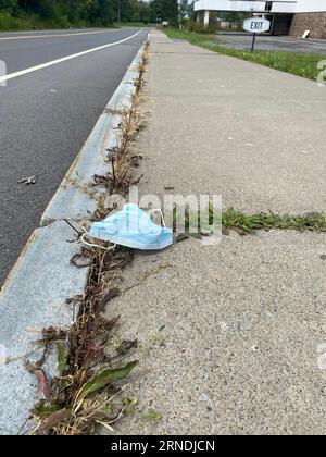 Face Mask Litter on a street Stock Photo