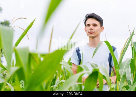 young guy farmer stands in a cornfield Stock Photo