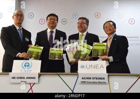 (160526) -- NAIROBI, May 26, 2016 -- UNEP Executive Director Achim Steiner (2nd R), Chinese Minister of Environment Protection Chen Jining (2nd L) together with other representatives hold the report entitled Green is gold: The strategy and actions of China s ecological civilization during a press conference of the second edition of the United Nations Environment Assembly in Nairobi, Kenya, May 26, 2016. An estimated 23 percent of total land mass in China will be covered by forests by 2020 if the Asian giant implements ambitious goals spelt out in its ecological civilization blueprint, said a U Stock Photo
