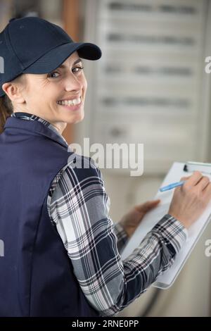 portrait of a female contractor holding a clipboard Stock Photo