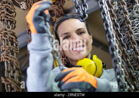 woman driving fork lift truck in warehouse Stock Photo