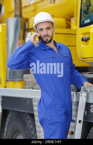busy dockworker using the phone with cargo transportation Stock Photo