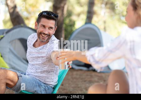 a couple standing at the campsite Stock Photo