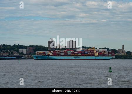 New York, USA - July 21st, 2023: A cargo ship, loaded with containers, entering the new york bay. Stock Photo