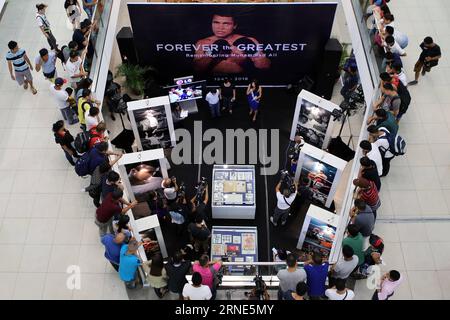 (160610) -- QUEZON CITY, June 10, 2016 -- People attend the opening of an exhibit commemorating Muhammad Ali inside a mall in Quezon City, the Philippines, June 10, 2016. The exhibit showcased vintage photos, posters, and other memorabilia from the 1975, when Muhammad Ali versus Joe Frazier boxing fight dubbed Thrilla in Manila , to pay tribute to Ali who died in Phoenix, Arizona, at the age of 74 on June 3, 2016. ) (zjy) PHILIPPINES-QUEZON CITY-MUHAMMAD ALI-TRIBUTE EXHIBIT RouellexUmali PUBLICATIONxNOTxINxCHN   160610 Quezon City June 10 2016 Celebrities attend The Opening of to Exhibit Comme Stock Photo