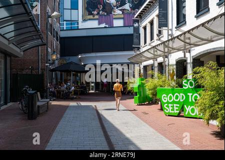 Weert, Limburg, The Netherlands, July 14, 2023 - Street towards the shopping gallery with terraces of restaurants Stock Photo