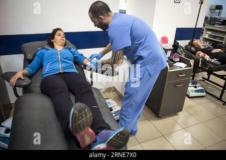 (160614) -- BUENOS AIRES, June 10, 2016 -- Image taken on June 10, 2016 shows a nurse working with a donor in the area of extractions of the Buenos Aires Hemocentro (Blood Center) Foundation, in Buenos Aires, capital of Argentina. The World Blood Donor Day is celebrated every year on June 14. In 2016, the theme of the campaign is Blood connects us all , the World Health Organization (WHO) has also adopted the slogan Share Life, Give Blood in order to raise awareness of the importance of systems of voluntary donation as a way of promoting community cohesion. ) (jp) (ah) ARGENTINA-BUENOS AIRES-W Stock Photo