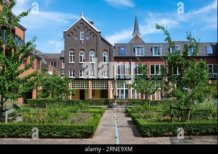 Weert, Limburg, The Netherlands, July 14, 2023 - Historical houses in a row, surrounded by a garden Stock Photo