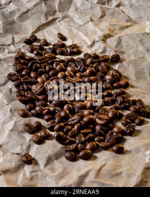 Roasted coffee beans in a pile on a paper background Stock Photo