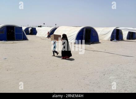 (160627) -- FALLUJAH, June 27, 2016 -- A boy carries relief goods in a camp for internally displaced people who fled from battles between the Iraqi army and the Islamic State in Khalidiya, Iraq, on June 27, 2016.) IRAQ-FALLUJAH-INTERNALLY DISPLACED PEOPLE KhalilxDawood PUBLICATIONxNOTxINxCHN   160627 Fallujah June 27 2016 a Boy carries Relief Goods in a Camp for Internally Displaced Celebrities Who fled from Battles between The Iraqi Army and The Islamic State in Khalidiya Iraq ON June 27 2016 Iraq Fallujah Internally Displaced Celebrities KhalilxDawood PUBLICATIONxNOTxINxCHN Stock Photo