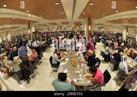 (160707) -- BANDAR SERI BEGAWAN, July 7, 2016 -- Bruneians and foreigners in Brunei enjoy free buffet during Hari Raya Aidil Fitri open house celebration at the Istana Nurul Iman palace in Bandar Seri Begawan, Brunei, July 7, 2016. The Istana Nurul Iman palace, the residence of Brunei s Sultan Haji Hassanal Bolkiah, opens to the public from July 7 to July 9. The Sultan, along with other members of the royal family, will celebrate the annual Muslim festival of Hari Raya Aidil Fitri with Bruneians and foreigners at the palace, providing every visitor with free buffet and souvenirs. Thousands of Stock Photo