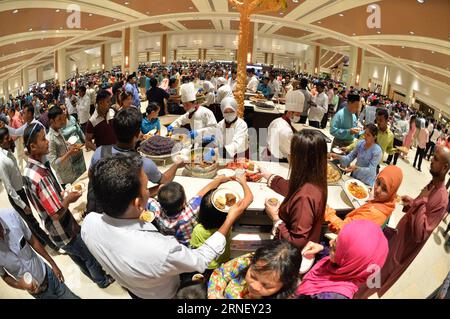 (160707) -- BANDAR SERI BEGAWAN, July 7, 2016 -- Bruneians and foreigners in Brunei wait for free cakes and cookies during Hari Raya Aidil Fitri open house celebration at the Istana Nurul Iman palace in Bandar Seri Begawan, Brunei, July 7, 2016. The Istana Nurul Iman palace, the residence of Brunei s Sultan Haji Hassanal Bolkiah, opens to the public from July 7 to July 9. The Sultan, along with other members of the royal family, will celebrate the annual Muslim festival of Hari Raya Aidil Fitri with Bruneians and foreigners at the palace, providing every visitor with free buffet and souvenirs. Stock Photo