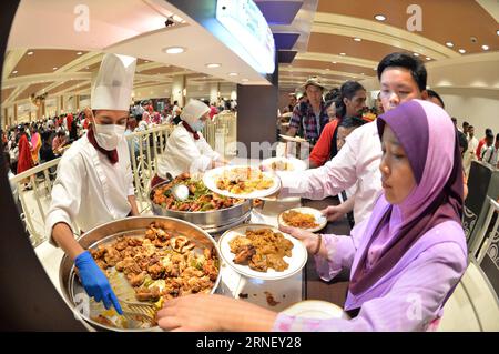 (160707) -- BANDAR SERI BEGAWAN, July 7, 2016 -- Bruneians and foreigners in Brunei queue up for free buffet during Hari Raya Aidil Fitri open house celebration at the Istana Nurul Iman palace in Bandar Seri Begawan, Brunei, July 7, 2016. The Istana Nurul Iman palace, the residence of Brunei s Sultan Haji Hassanal Bolkiah, opens to the public from July 7 to July 9. The Sultan, along with other members of the royal family, will celebrate the annual Muslim festival of Hari Raya Aidil Fitri with Bruneians and foreigners at the palace, providing every visitor with free buffet and souvenirs. Thousa Stock Photo