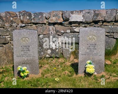Two War Graves with flowers of unknown sailors of the merchant navy who lost their lives in the Second World War. Taken on a sunny day with a blue sky Stock Photo