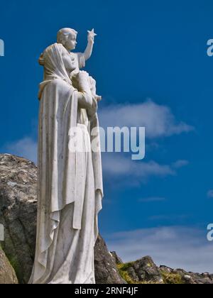 The white statue of Our Lady of the Sea near the top of the hill of Heaval on the island of Barra in the Outer Hebrides, Scotland, UK. Taken on a sunn Stock Photo