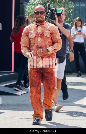 Monza, Italy. 1st Sep, 2023. LEWIS HAMILTON of Mercedes arrives wearing an orange acid wash denim outfit with black boots during practice day ahead of the F1 Grand Prix of Italy at Autodromo Nazionale Monza. (Credit Image: © Beata Zawrzel/ZUMA Press Wire) EDITORIAL USAGE ONLY! Not for Commercial USAGE! Stock Photo