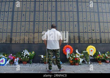 (160728) -- TANGSHAN, July 28, 2016 -- A man mourns for victims of the 1976 Tangshan earthquake in front of a memorial wall in Tangshan, north China s Hebei Province, July 28, 2016. Local residents came to the Tangshan Earthquake Ruins Memorial Park on Thursday to mark the 40th anniversary of the devastating earthquake that killed their family members and friends. )(wsw) CHINA-HEBEI-TANGSHAN-EARTHQUAKE-COMMEMORATION (CN) MouxYu PUBLICATIONxNOTxINxCHN   160728 Tang Shan July 28 2016 a Man mourns for Victims of The 1976 Tang Shan Earthquake in Front of a Memorial Wall in Tang Shan North China S Stock Photo