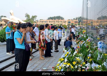 (160728) -- TANGSHAN, July 28, 2016 -- Residents mourn for victims of the 1976 Tangshan earthquake in front of a memorial wall in Tangshan, north China s Hebei Province, July 28, 2016. Local residents came to the Tangshan Earthquake Ruins Memorial Park on Thursday to mark the 40th anniversary of the devastating earthquake that killed their family members and friends. )(wsw) CHINA-HEBEI-TANGSHAN-EARTHQUAKE-COMMEMORATION (CN) MouxYu PUBLICATIONxNOTxINxCHN   160728 Tang Shan July 28 2016 Residents Morne for Victims of The 1976 Tang Shan Earthquake in Front of a Memorial Wall in Tang Shan North Ch Stock Photo