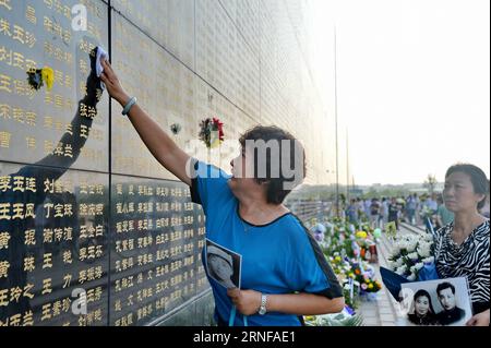 (160728) -- TANGSHAN, July 28, 2016 -- A woman touches the name of her relative killed in the 1976 Tangshan earthquake listed on a memorial wall in Tangshan, north China s Hebei Province, July 28, 2016. Local residents came to the Tangshan Earthquake Ruins Memorial Park on Thursday to mark the 40th anniversary of the devastating earthquake that killed their family members and friends. )(wsw) CHINA-HEBEI-TANGSHAN-EARTHQUAKE-COMMEMORATION (CN) MouxYu PUBLICATIONxNOTxINxCHN   160728 Tang Shan July 28 2016 a Woman touches The Name of her relative KILLED in The 1976 Tang Shan Earthquake Listed ON a Stock Photo