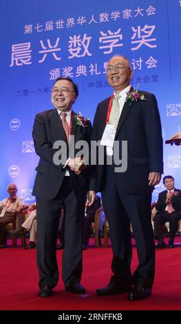 (160806) -- BEIJING, Aug. 6, 2016 -- Ronnie Chan (L), co-founder of Morningside Group and Morningside Foundation in south China s Hong Kong, receives the Chern Medal award at the opening ceremony of the 7th International Congress of Chinese Mathematicians (ICCM) in Beijing, capital of China, Aug. 6, 2016. The Chern Medal, an international award recognizing outstanding lifelong achievement of the highest level in the field of mathematics, is named in honor of late Chinese mathematician Shiing-Shen Chern (Chen Xingshen). The congress is a triennial event that brings together Chinese and overseas Stock Photo