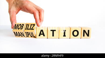 Mobilization or manipulation symbol. Concept words Mobilization Manipulation on wooden cubes. Beautiful white background. Psychologist hand. Psycholog Stock Photo