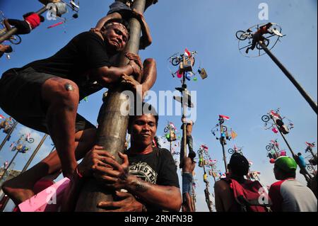 (160817) -- JAKARTA, Aug. 17, 2016 -- Indonesian men climb greased poles during celebrations of the 71st anniversary of Indonesian Independence Day in Jakarta, Indonesia, on Aug. 17, 2016. Every year people around Jakarta city climb hundreds of poles, trying to get prizes on the top of the poles to celebrate the Indonesian Independence Day. ) (wtc) INDONESIA-JAKARTA-INDEPENDENCE DAY-POLE CLIMBING Zulkarnain PUBLICATIONxNOTxINxCHN   160817 Jakarta Aug 17 2016 Indonesian Men CLIMB Greased Poles during celebrations of The 71st Anniversary of Indonesian Independence Day in Jakarta Indonesia ON Aug Stock Photo