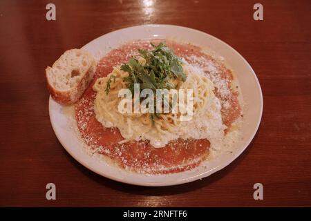 Truffle tagliatelle pasta on carpaccio beef. Stock Photo