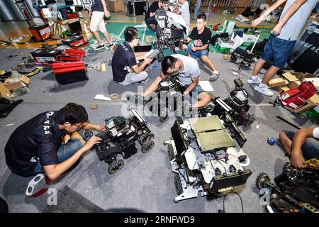 Students from China University of Mining and Technology debug robots during the final of RoboMasters college students robot contest in Shenzhen, south China s Guangdong Province, Aug. 25, 2016. Thirty-two teams participate in the four-day contest. )(mcg) CHINA-GUANGDONG-SHENZHEN-ROBOT CONTEST (CN) MaoxSiqian PUBLICATIONxNOTxINxCHN   Students from China University of Mining and Technology DeBug ROBOTS during The Final of  College Students Robot Contest in Shenzhen South China S Guangdong Province Aug 25 2016 Thirty Two Teams participate in The Four Day Contest McG China Guangdong Shenzhen Robot Stock Photo