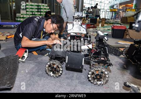 A student from China University of Mining and Technology debugs a robot during the final of RoboMasters college students robot contest in Shenzhen, south China s Guangdong Province, Aug. 25, 2016. Thirty-two teams participate in the four-day contest. )(mcg) CHINA-GUANGDONG-SHENZHEN-ROBOT CONTEST (CN) MaoxSiqian PUBLICATIONxNOTxINxCHN   a Student from China University of Mining and Technology debug a Robot during The Final of  College Students Robot Contest in Shenzhen South China S Guangdong Province Aug 25 2016 Thirty Two Teams participate in The Four Day Contest McG China Guangdong Shenzhen Stock Photo
