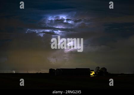 Thunderstorm is illuminated by lightning at night Stock Photo