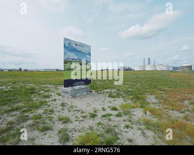 Sign on a plot of land in an industrial area near Borssele, Zeeland, the Netherlands, showing that soon construction will start of a h2 gas factory Stock Photo