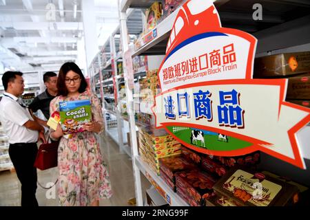 (160914) -- BEIJING, Sept. 14, 2016 -- Customers select imported goods carried by Zhengzhou-Europe International Block Train in Zhengzhou, capital of central China s Henan Province, Aug. 18, 2016. Zhengzhou is one of the Chinese cities having direct cargo trains to Europe. Starting from Zhengzhou, a logistics center and transport hub in Henan, the 10,214-kilometer Zhengzhou-Europe international shuttle train crosses the border at the Alataw Pass in Xinjiang before passing through Kazakhstan, Russia, Belarus and Poland on its way to Germany s Hamburg. The Zhengzhou-Europe express railway servic Stock Photo