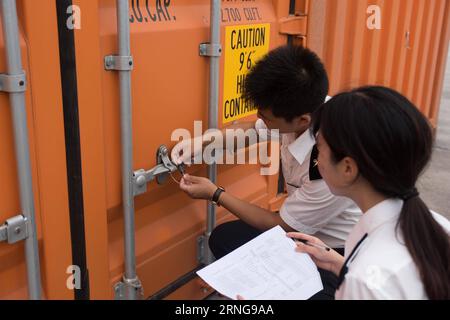 (160914) -- BEIJING, Sept. 14, 2016 -- Customs officers lock a checked container at the railway container center in Zhengzhou, capital of central China s Henan Province, Aug. 19, 2016. Zhengzhou is one of the Chinese cities having direct cargo trains to Europe. Starting from Zhengzhou, a logistics center and transport hub in Henan, the 10,214-kilometer Zhengzhou-Europe international shuttle train crosses the border at the Alataw Pass in Xinjiang before passing through Kazakhstan, Russia, Belarus and Poland on its way to Germany s Hamburg. The Zhengzhou-Europe express railway service, which ope Stock Photo