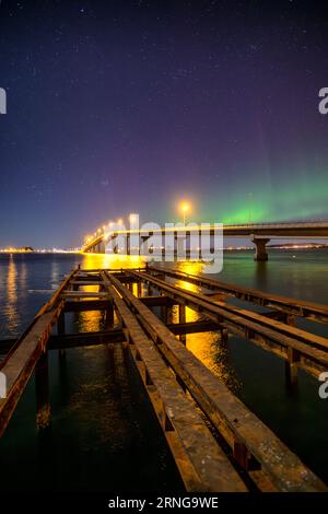 The Northern Lights over Giske bridge from Valderøya, Ålesund, Norway Stock Photo