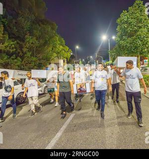 Haifa, Israel - August 31, 2023: People carry symbolic coffins, part of the march of the dead protest against rising violence and murder rate in the A Stock Photo