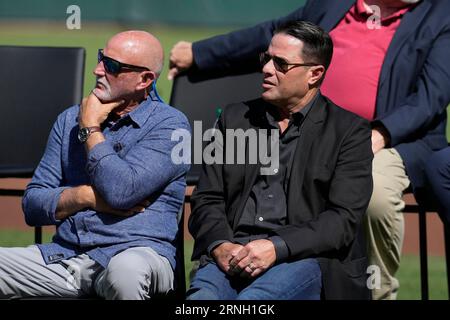 Former San Francisco Giants' Will Clark, left, hugs Robby Thompson as they  take the field as part of a tribute to the Giants' 1987 team before the  baseball game against the Florida