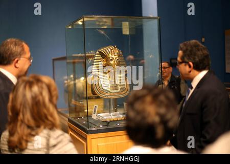 (161117) -- CAIRO, Nov. 17, 2016 -- People look at the golden mask of King Tutankhamen, one of ancient Egypt s most famous artifacts, in the Egyptian Museum in Cairo, capital of Egypt, on Nov. 17, 2016. The Egyptian Museum on Thursday celebrated the 114th anniversary of its opening of the current building at Tahrir Square. In 1902, the collections in the museum were moved to the current building at Tahrir Square. ) EGYPT-CAIRO-THE EGYPTIAN MUSEUM-TAHRIR SQUARE-BUILDING-114TH ANNIVERSARY AhmedxGomaa PUBLICATIONxNOTxINxCHN   Cairo Nov 17 2016 Celebrities Look AT The Golden Mask of King Tutankham Stock Photo