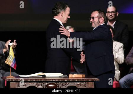 Kolumbien schließt neues Abkommen mit FARC-Guerilla (161124) -- BOGOTA, Nov. 24, 2016 -- Colombian President Juan Manuel Santos (L) and the leader of the Revolutionary Armed Forces of Colombia (FARC), Rodrigo Londono (R, front), shake hands during the signing ceremony of a revised peace agreement between the Colombian government and the FARC at Colon Theater in Bogota, capital of Colombia, on Nov. 24, 2016. Juan Manuel Santos and Rodrigo Londono signed a revised peace agreement here on Thursday. This revised agreement will be sent to Congress. ) (ce) COLOMBIA-BOGOTA-GOVERNMENT-FARC-REVISED PEA Stock Photo
