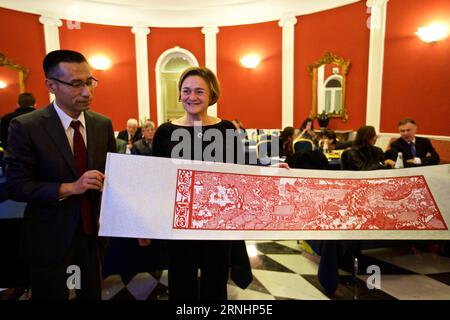 (161203) -- ROME, Dec. 3, 2016 -- Cui Yanchao (1st L), director of Beijing Municipal Commission of Tourism Development Administrative Office, presents the Chinese paper-cut Riverside Scene at Qing Ming Festival to Alessandra Zita(C), official of Italy s National Agency of Tourism (ENIT), during an event to promote Beijing Tourism in Rome, Italy, Dec. 2, 2016, ) (yy) ITALY-ROME-BEIJING-TOURISM-PROMOTION jinxyu PUBLICATIONxNOTxINxCHN   Rome DEC 3 2016 Cui  1st l Director of Beijing Municipal Commission of Tourism Development Administrative Office Presents The Chinese Paper Cut Riverside Scene AT Stock Photo