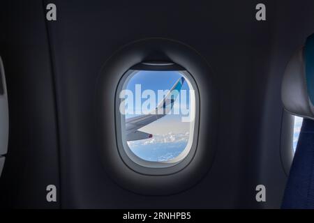 Airplane window view from the porthole of the plane. Copy Space. Stock Photo