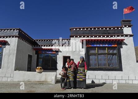 (161209) -- GYIRONG, Dec. 9, 2016 -- Villagers pose for photo in front of their new house in Gyirong County of Xigaze City, southwest China s Tibet Autonomous Region, Dec. 7, 2016. Over 16,000 people were affected by the quake which hit the county on April 25, 2015. More than 3,000 residential buildings were badly damaged. The local government has reconstructed 89.6% of houses for villagers so far. The rest will be finished by the end of the year. ) (mp) CHINA-TIBET-GYIRONG-QUAKE-RECONSTRUCTION (CN) LiuxDongjun PUBLICATIONxNOTxINxCHN   Gyirong DEC 9 2016 Villagers Pose for Photo in Front of th Stock Photo