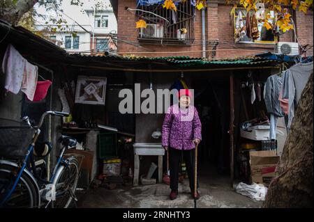 (161211) -- NANJING, Dec. 11, 2016 -- Yi Cuilan stands in front of the house she rented in Nanjing, east China s Jiangsu Province, Nov. 25, 2016. Yi Cuilan, born on May 6, 1923, survived from the invasion of Japanese troops by pretending to be a boy, seeking asylum from different refugee camps. Although she escaped from death, she suffered from severe pains all these years due to the brutal assault by Japanese invaders. Japanese troops occupied eastern China s Nanjing on Dec. 13, 1937, and began a six-week massacre. Chinese records show more than 300,000 people -- not only disarmed soldiers bu Stock Photo