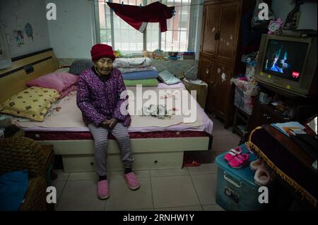 (161211) -- NANJING, Dec. 11, 2016 -- Yi Cuilan stays at a house she rented in Nanjing, east China s Jiangsu Province, Nov. 25, 2016. Yi Cuilan, born on May 6, 1923, survived from the invasion of Japanese troops by pretending to be a boy, seeking asylum from different refugee camps. Although she escaped from death, she suffered from severe pains all these years due to the brutal assault by Japanese invaders. Japanese troops occupied eastern China s Nanjing on Dec. 13, 1937, and began a six-week massacre. Chinese records show more than 300,000 people -- not only disarmed soldiers but also civil Stock Photo