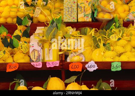 A n Italian trader specializing in a large variety of products and souvenirs based on Amalfi lemons displayed for sale at a shop in Amalfi, Italy. Stock Photo