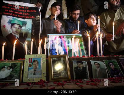 (161215) -- PESHAWAR (PAKISTAN), Dec. 15, 2016 -- People hold candles beside the pictures of their family members who were killed in an attack on a Peshawar school in 2014, during a ceremony marking the second anniversary of the attack, in Peshawar, northwestern Pakistan, on Dec. 15, 2016. On Dec. 16, 2014, a group of armed militants disguised as military men attacked a military-run school in Peshawar, killing at least 141 people --132 children and nine staff members, while injuring 133 others. ) PAKISTAN-PESHAWAR-SCHOOL ATTACK-SECOND ANNIVERSARY-VIGIL AhmadxSidique PUBLICATIONxNOTxINxCHN   16 Stock Photo